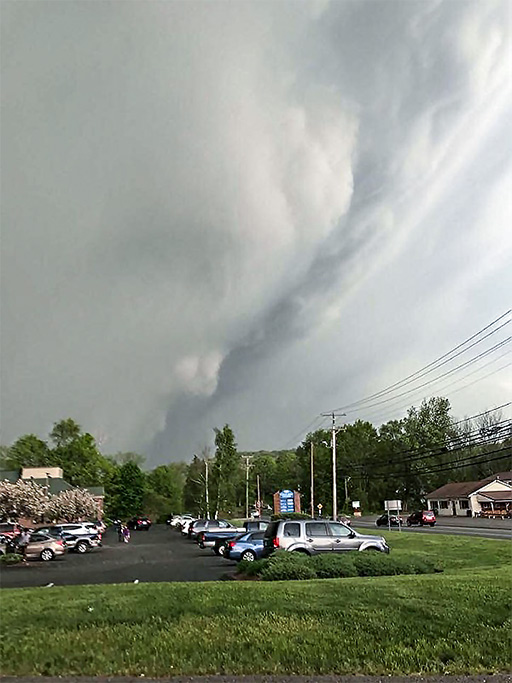 Photo of street scene showing wall cloud and tornado